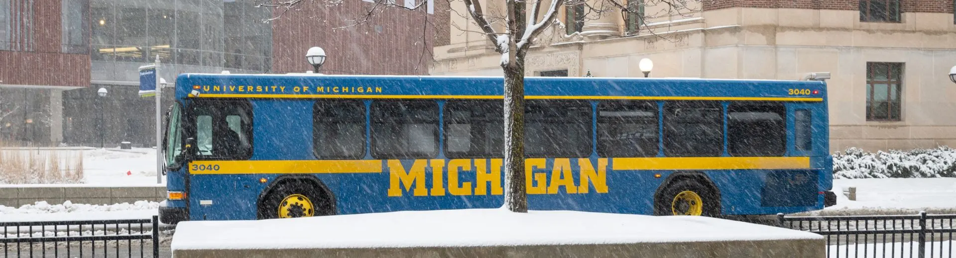 A U-M bus traveling through campus in the snow