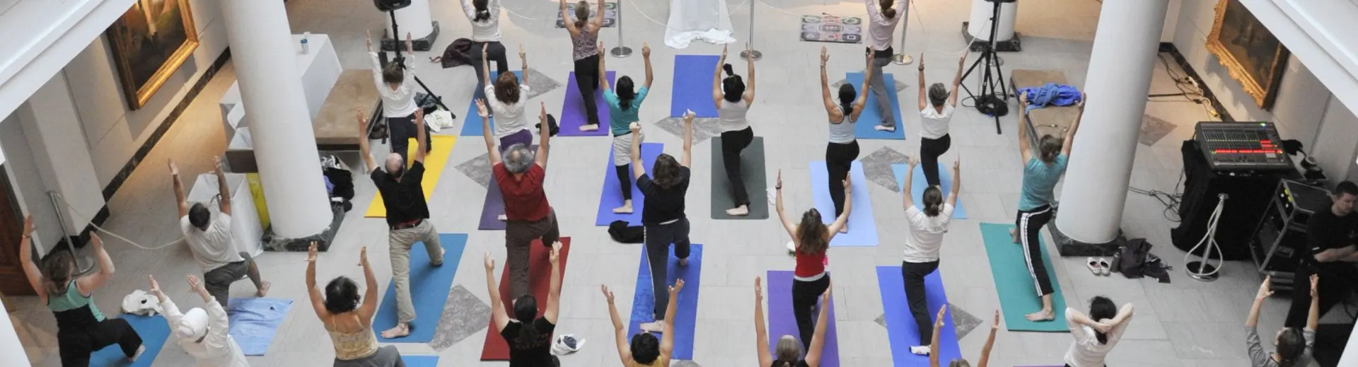 A yoga class held in the atrium of UMMA